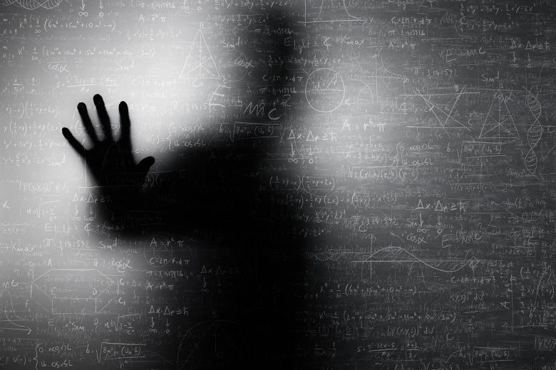 The silhouette of a male scientist, looking menacing as he touches a board filled with equations.